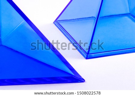 Light blue plastic geometric shapes on a white background
