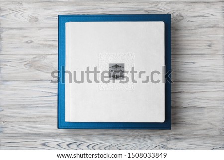 blue stylish square cardboard box for a photo album.
Bright original box for white wedding album.
leather photo book in the open box
blue cardboard box for a photo book