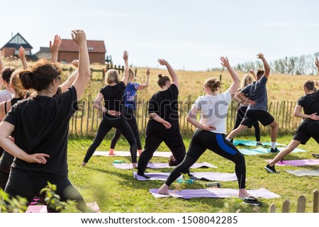 A yoga teacher holding a class of goat yoga which is taking the world by storm Royalty-Free Stock Photo #1508042285