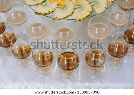 Festive table with cold exotic alcoholic beverages, cocktails and fruits. Celebration or other event
