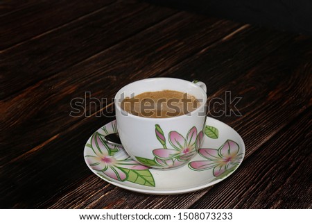 Cup of hot latte coffee on a dark wooden table, selective focus ,. Comfort and warmth in the house in the cold autumn,
