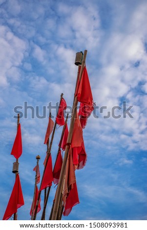 Red flags with blue sky in background