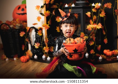 Toddler girl dressed up playing in Halloween party