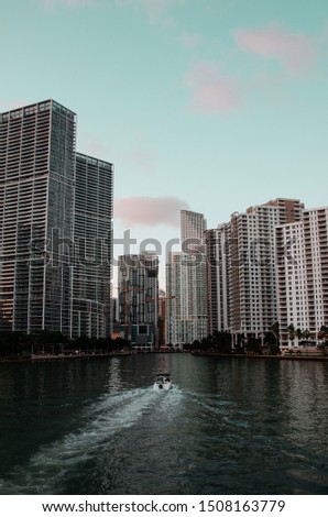 Brickell, Miami during sunset with boat driving by