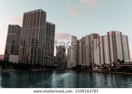 Brickell, Miami during sunset with boat driving by
