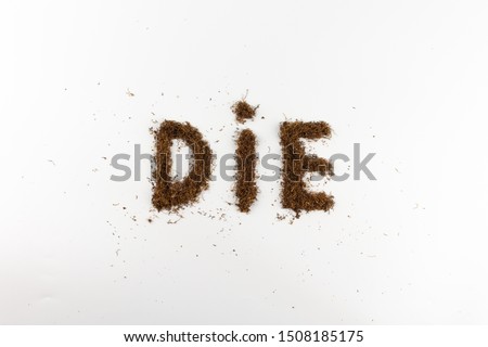 close-up of the word die made of tobacco on a white background