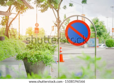 outdoor no parking sign beside road with blurred background