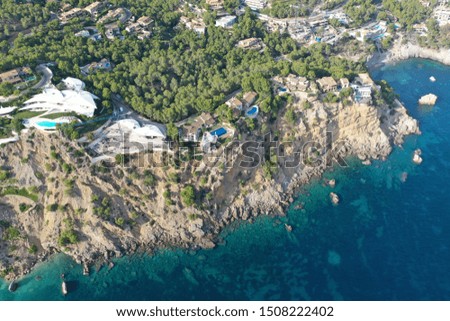 Mallorca island beautiful aerial image of the coast and Paguera beach luxury homes green mountains wonderful sky yachts and sailboats blue waters