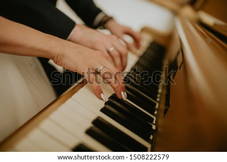 
The bride and groom play the piano