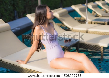 Portrait beautiful asian women happy smile relax around swimming pool in hotel resort for holiday vacation
