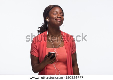 Young African American woman listening to iPod, horizontal Royalty-Free Stock Photo #150826997