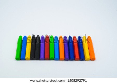 School supplies, colourful crayons stationery on white background.