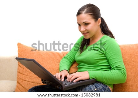 attractive brunette woman on sofa with laptop