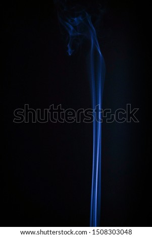Smoke incense on a black or dark background closeup. Religion symbol concept