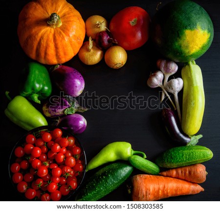 Happy Thanksgiving Day background, black wooden table decorated with pumpkins and autumn vegetables. Harvest festival. Colorful photo with copy space.