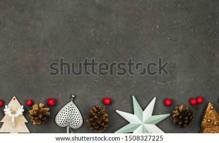 cones, Christmas decor and red small apples on a rough dark gray background with space for text