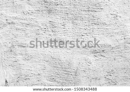 white and gray abstract textured plaster on the wall