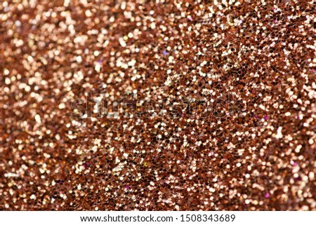 Shimmering copper glitter macro abstract texture background with bokeh