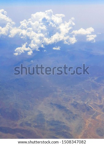 AERIAL VIEW OF CLOUDS AND MOUNTAINS
