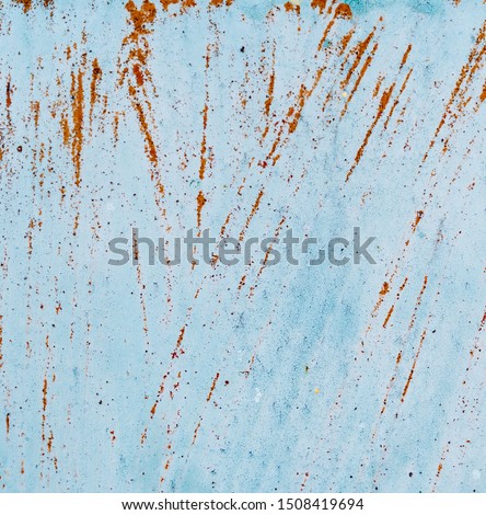 Surface covered with blue paint. Rusty orange lines on the surface. Metal texture. Background for text or design. Square picture