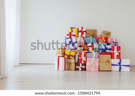 A lot of colorful gifts in the interior of the white room