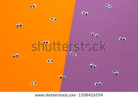 Halloween googly eyes color block orange and purple background