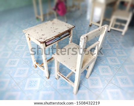 Student tables with different textbooks, copybooks in school classroom background. Interior of school classroom. Education background.