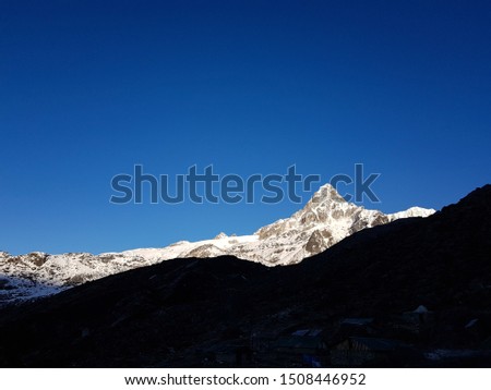 The golden sunlight falls on top of the Mt. Frey Peak near Rathong Glacier on a early morning, West sikkim, India