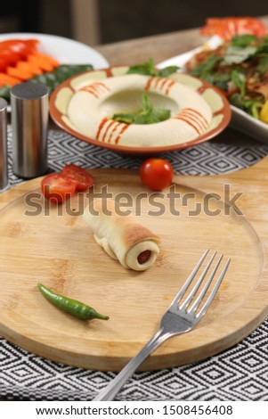 hot dog mini fatayer on wood plate