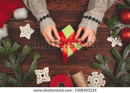 Christmas preparations concept. Woman wrapping gifts close up