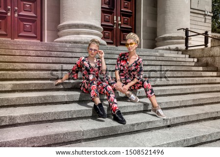 Mother and daughter fashion. Mother and daughter posing in same floral outfits in summer day in town outdoor. Fashionable family - Image. Summer fashion.