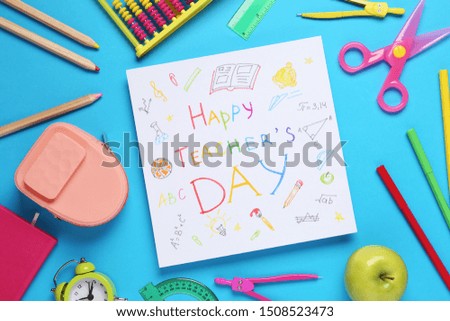 Flat lay composition of card with inscription HAPPY TEACHER'S DAY and stationery on blue background