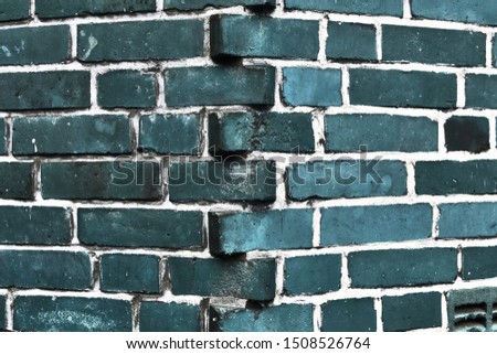 Detailed close up view on weathered blue brick walls at aged buildings in high resolution