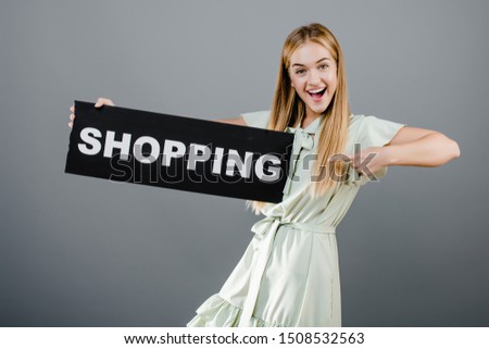 happy smiling beautiful blonde girl with shopping sign isolated