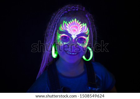 Light hair girl with neon face painting Royalty-Free Stock Photo #1508549624