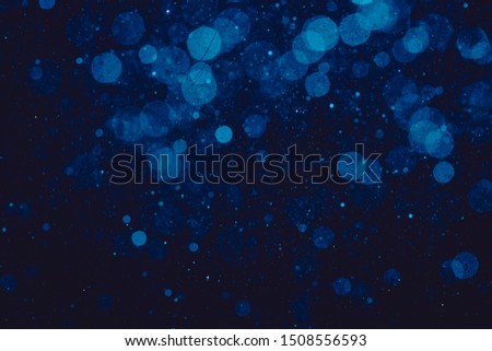 blue bokeh of lights on black background