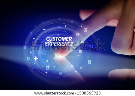 Finger touching tablet with social media icons and CUSTOMER EXPERIENCE