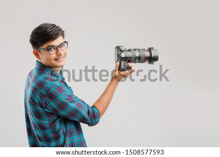 Young Indian man capturing photo with camera