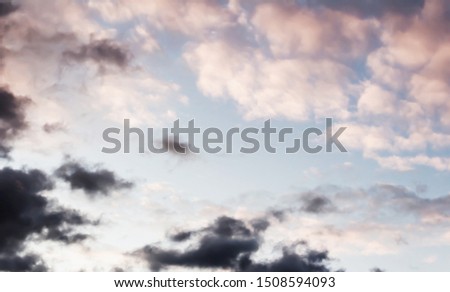 Soft pink clouds with evening dak clouds against a blue sky with lomography, background childhood in nursery