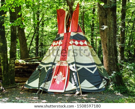 Wigwam at forest background. Conical dwelling of Native Americans Royalty-Free Stock Photo #1508597180