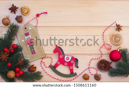 Christmas flat lay on a wooden background. Wooden Christmas toys and Christmas decor. Nutcracker and wooden horse