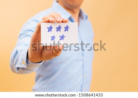 Businessman showing five yellow stars card in bright color background. Review, rating, ranking and evaluation concept