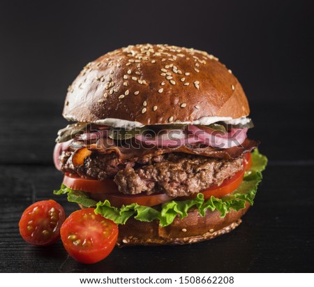 Beef burger with lettuce and cherry tomatoes 