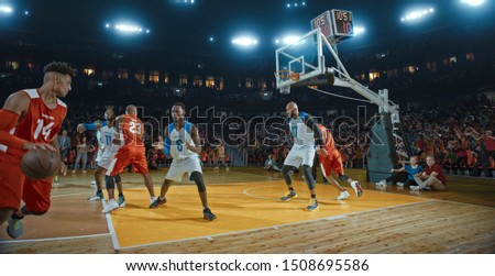 Basketball players on big professional arena during the game. Tense moment of the game. Celebration