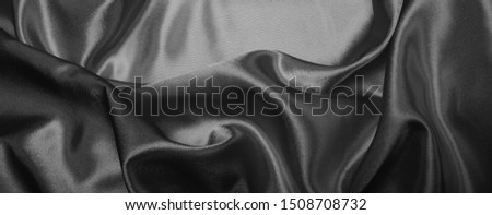 Abstract black and white swirl silk fabric background. Horizontal long banner.