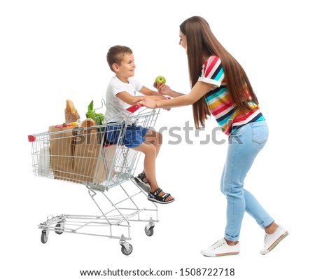 Mother and son with full shopping cart on white background