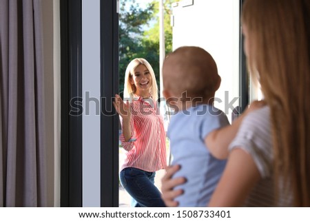 Mother leaving her baby with teen nanny at home Royalty-Free Stock Photo #1508733401