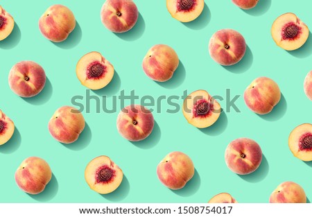Colorful fruit pattern of fresh peaches on green pastel background Royalty-Free Stock Photo #1508754017