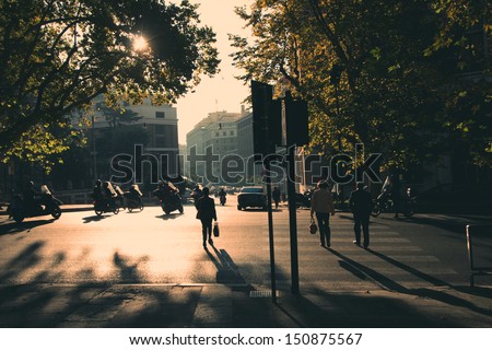 Rome in early morning. Street view. People crossing the street. Retro tinted photo