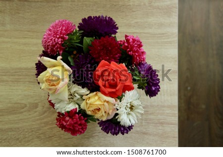 Beautiful floral bouquet of fresh different flowers on wooden table